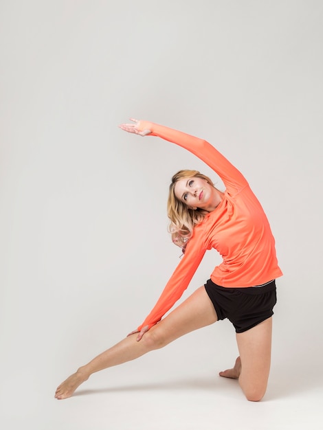 Free photo front view of woman stretching her body