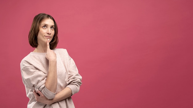 Front view of woman striking a thinking pose