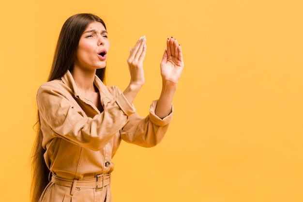 Free photo front view woman in studio with copy space