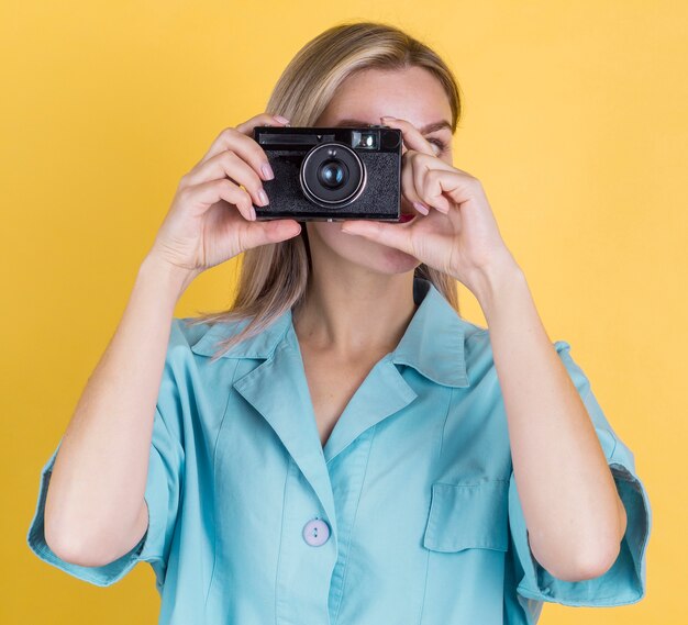 Front view woman taking a photo