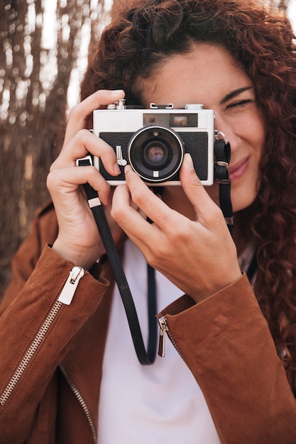 Front view woman taking photos