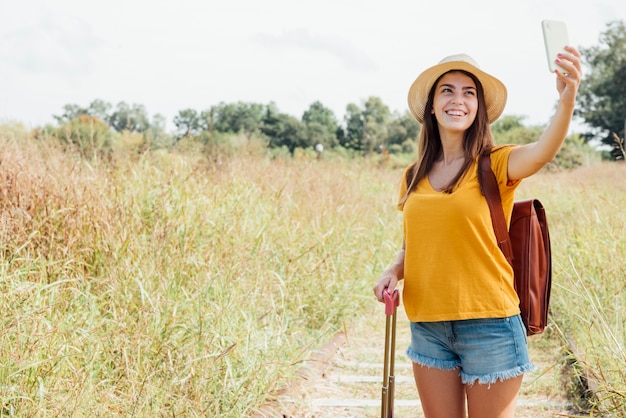 Free photo front view of woman taking a selfie