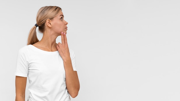 Free photo front view of woman touching her chin to check for pain with copy space