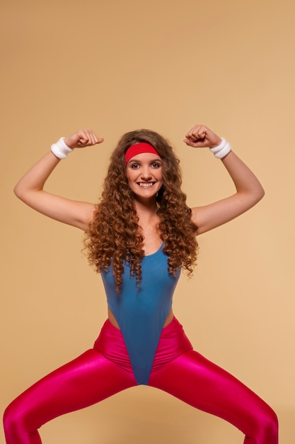 Free photo front view woman training with  80's outfit