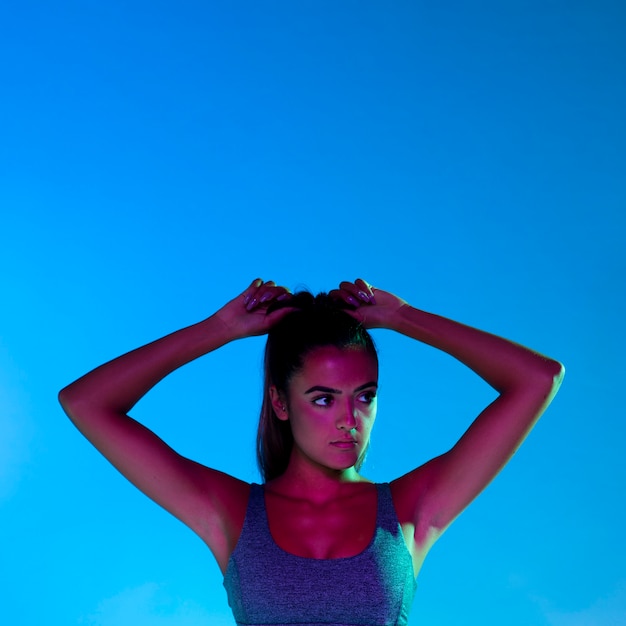 Free photo front view of woman tying her hair