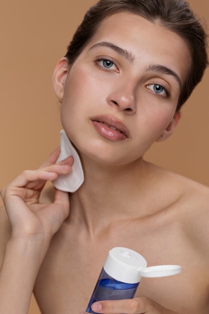 Front view woman using cleansing product