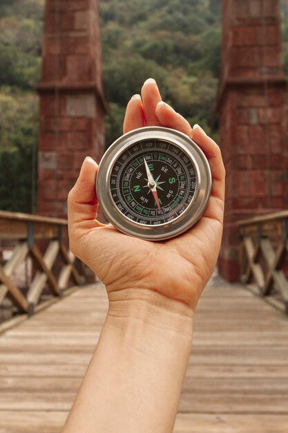 Front view woman using compass for directions