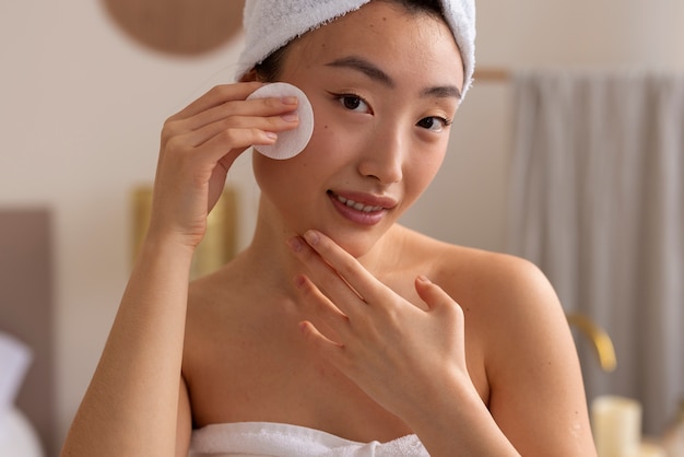 Front view woman using cotton pad