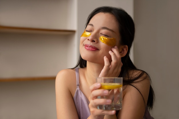 Front view woman using eye patches