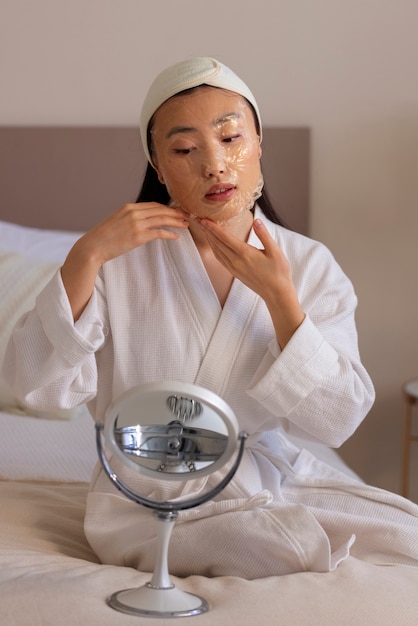 Free photo front view woman using face mask