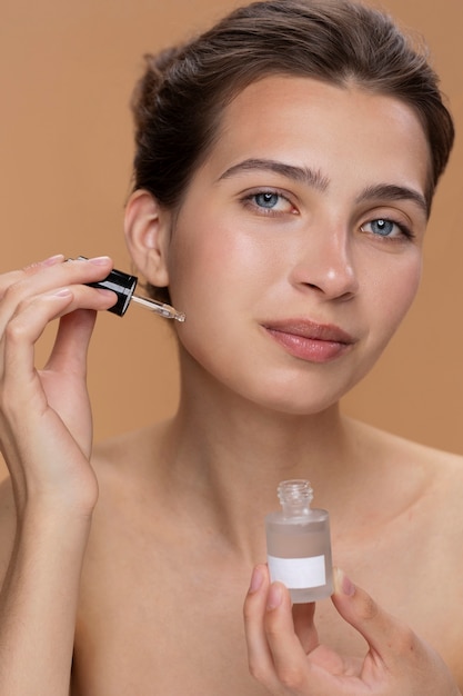 Front view woman using face serum