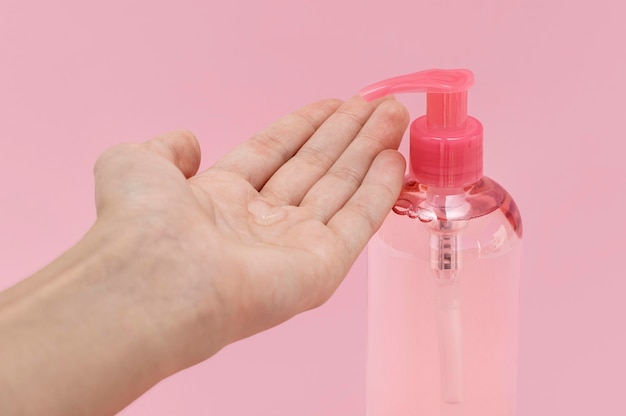 Free photo front view woman using liquid soap