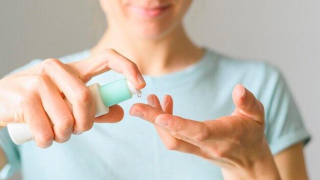 Front view of woman using lotion