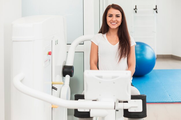 Front view woman using medical machine