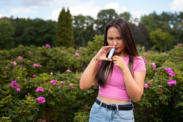 Front view woman using nasal spray