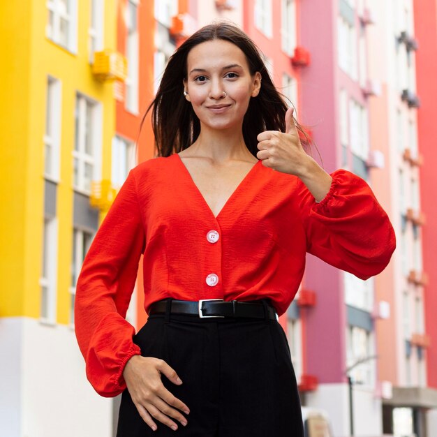 Front view of woman using sign language outside