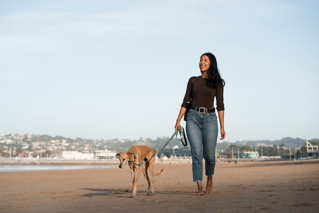 Front view woman walking with dog