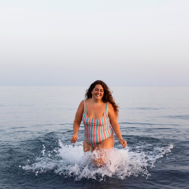 Free photo front view of woman in the water at the beach