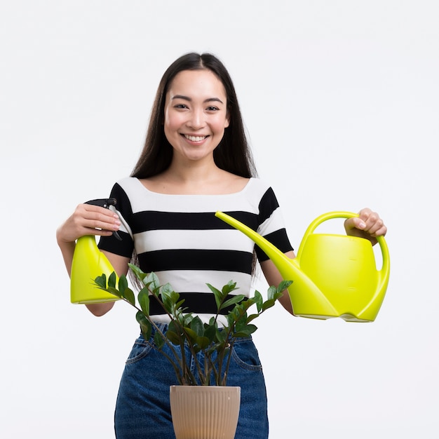 Front view woman watering flower