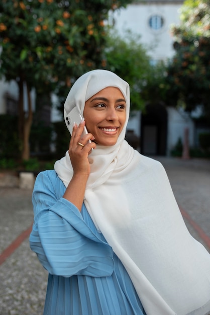 Free photo front view woman wearing halal outdoors