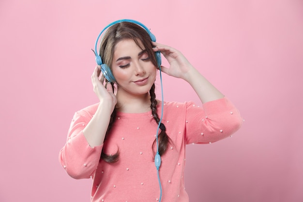 Front view of woman wearing headphones enjoying music