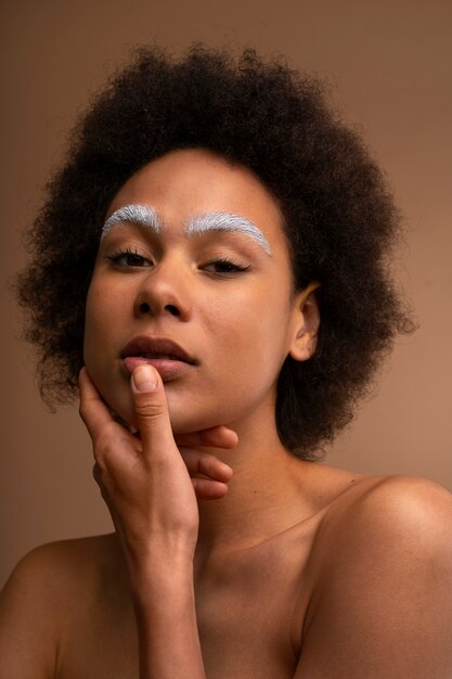 Front view woman wearing  makeup with thick eyebrows