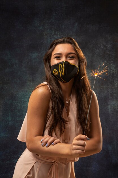 Front view of woman wearing a mask with a firework