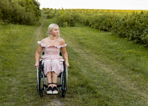 Front view of woman in wheelchair outdoors