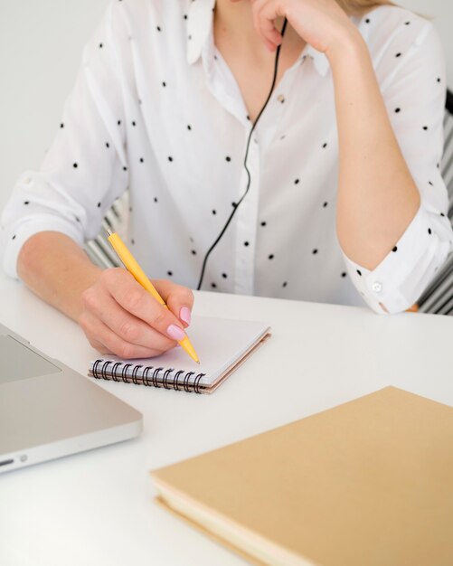 front view woman in white shirt writing