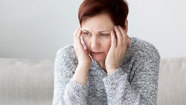 Free photo front view of woman with anxiety on couch