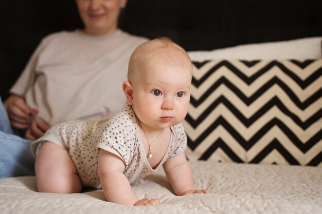 Front view woman with baby in bed