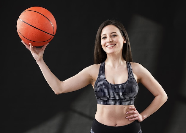 Front view of woman with basketball ball