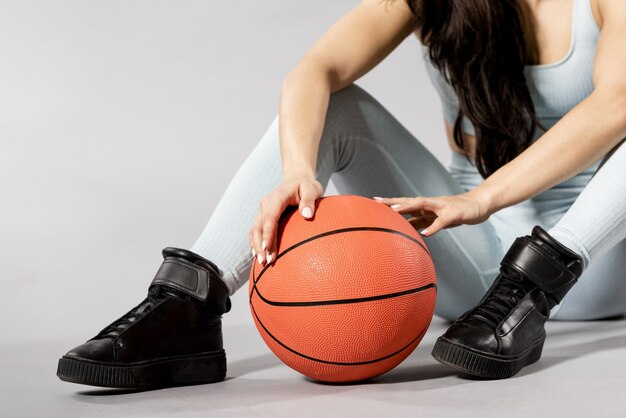 Front view of woman with basketball ball