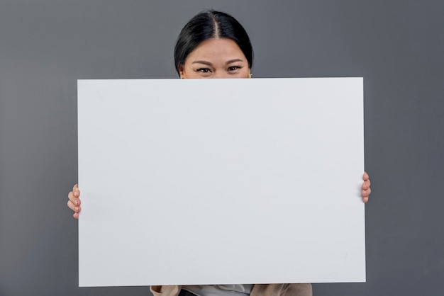 Front view woman with blank paper sheet