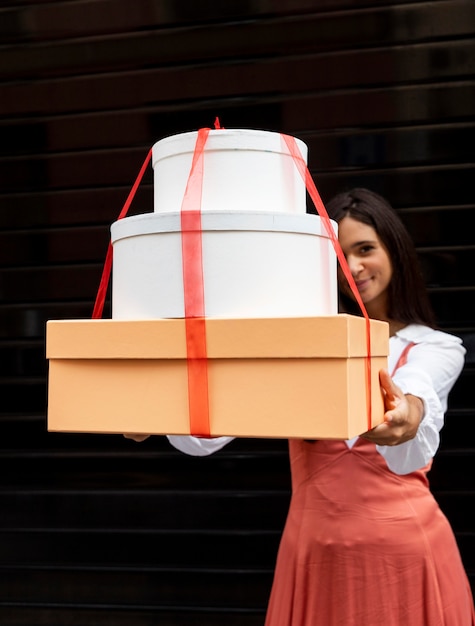 Free photo front view of woman with boxes