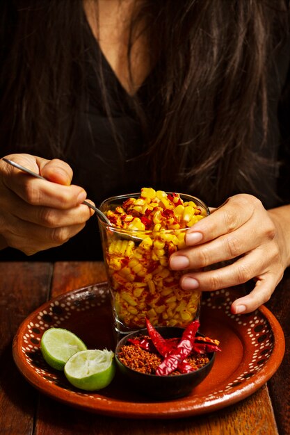 Front view woman with delicious esquites