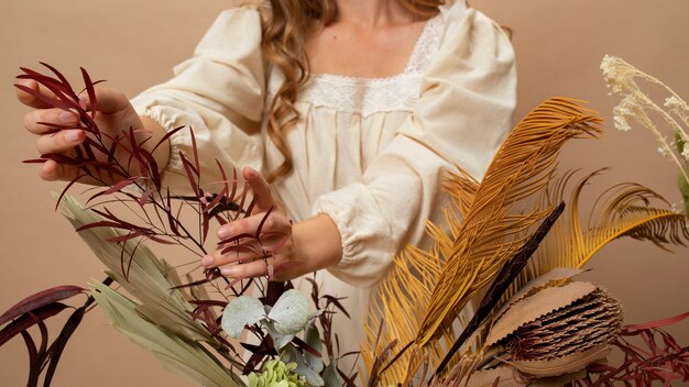 Front view woman with dried plants