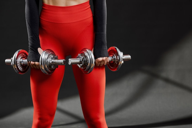 Front view of woman with dumbbells