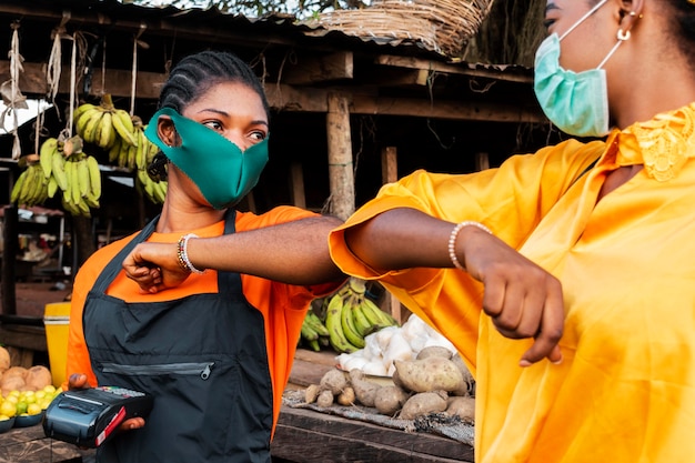 Free photo front view of woman with face mask in market