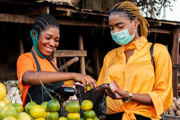 Front view of woman with face mask in market