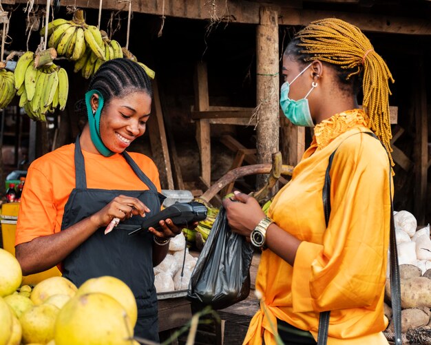 Front view of woman with face mask in market