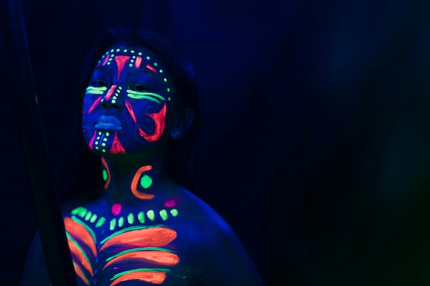 Free photo front view of woman with fluorescent make-up