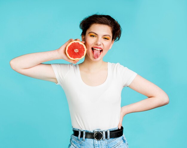Front view of woman with grapefruit