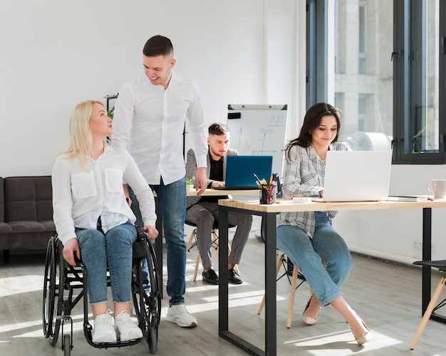 Front view of woman with her coworkers in office