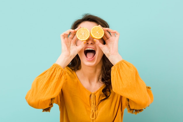 Front view of woman with lemon slices