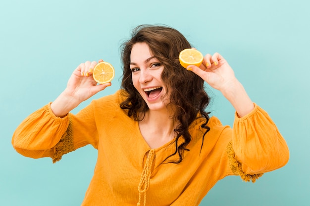 Front view of woman with lemon