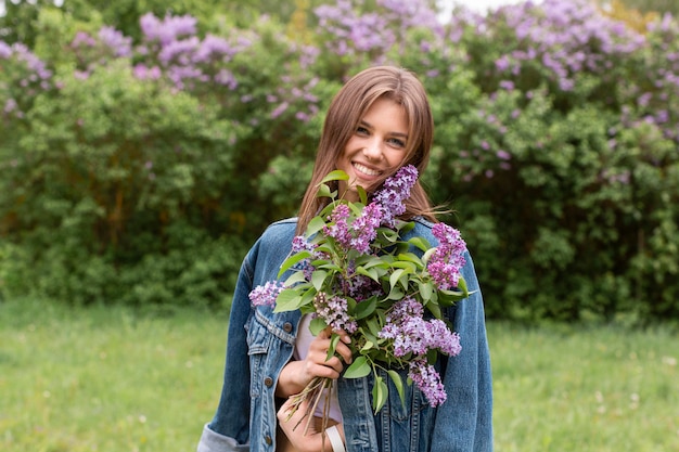 Front view woman with lilac bouquet
