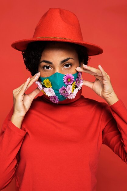 Front view of woman with mask and flowers