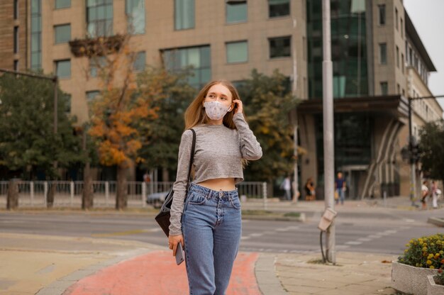 Front view woman with medical mask outside
