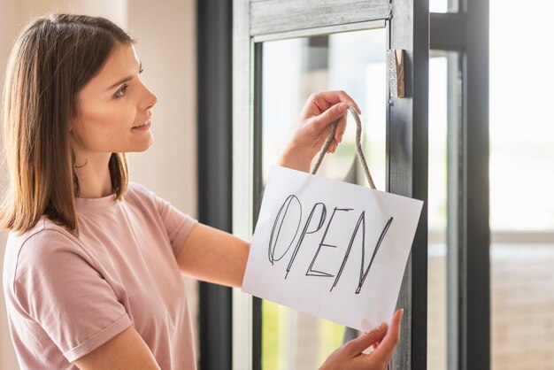 Front view of woman with open sign